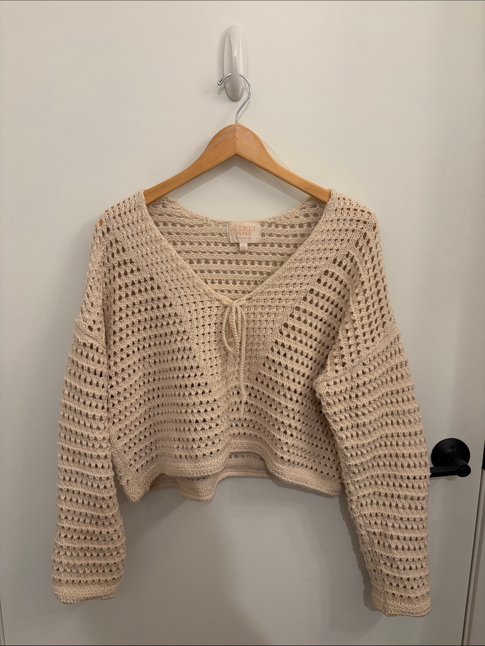 Audrey Parks + Francesca’s Open-Knit Cropped Off-Shoulder Sweater in Cream